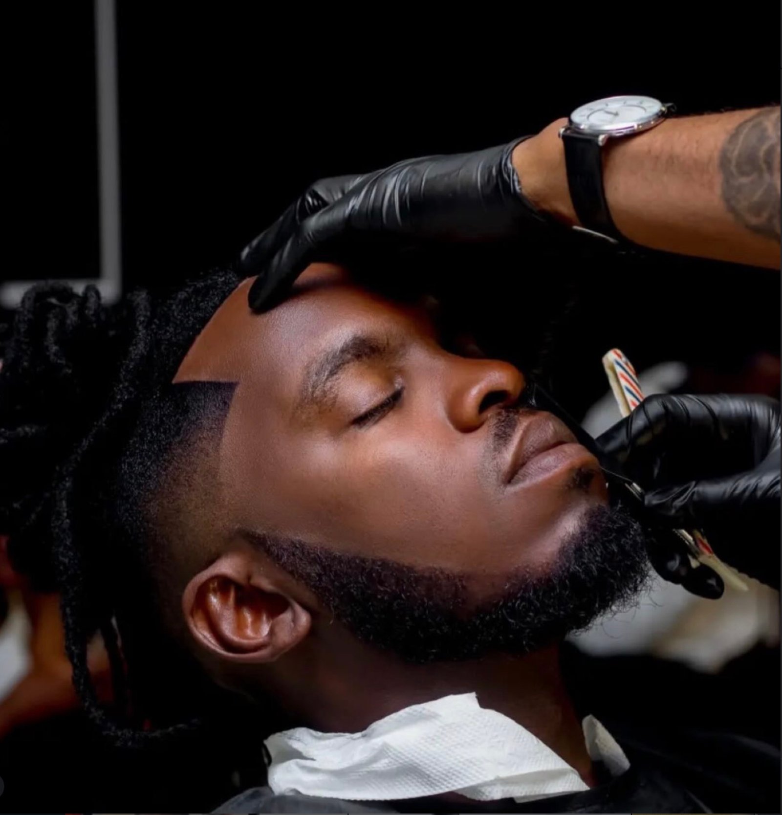 Barber giving a precision beard line-up at Joe's Fade Cuts